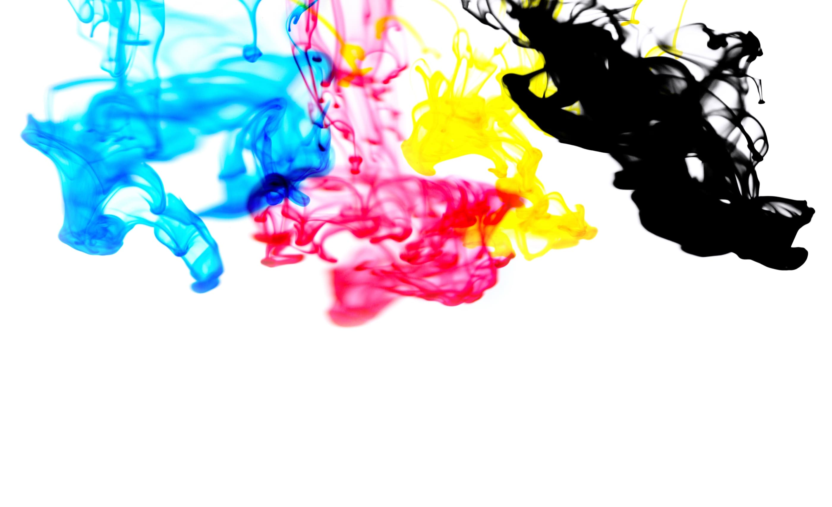 Cyan, magenta, yellow and black ink drops blooming in water