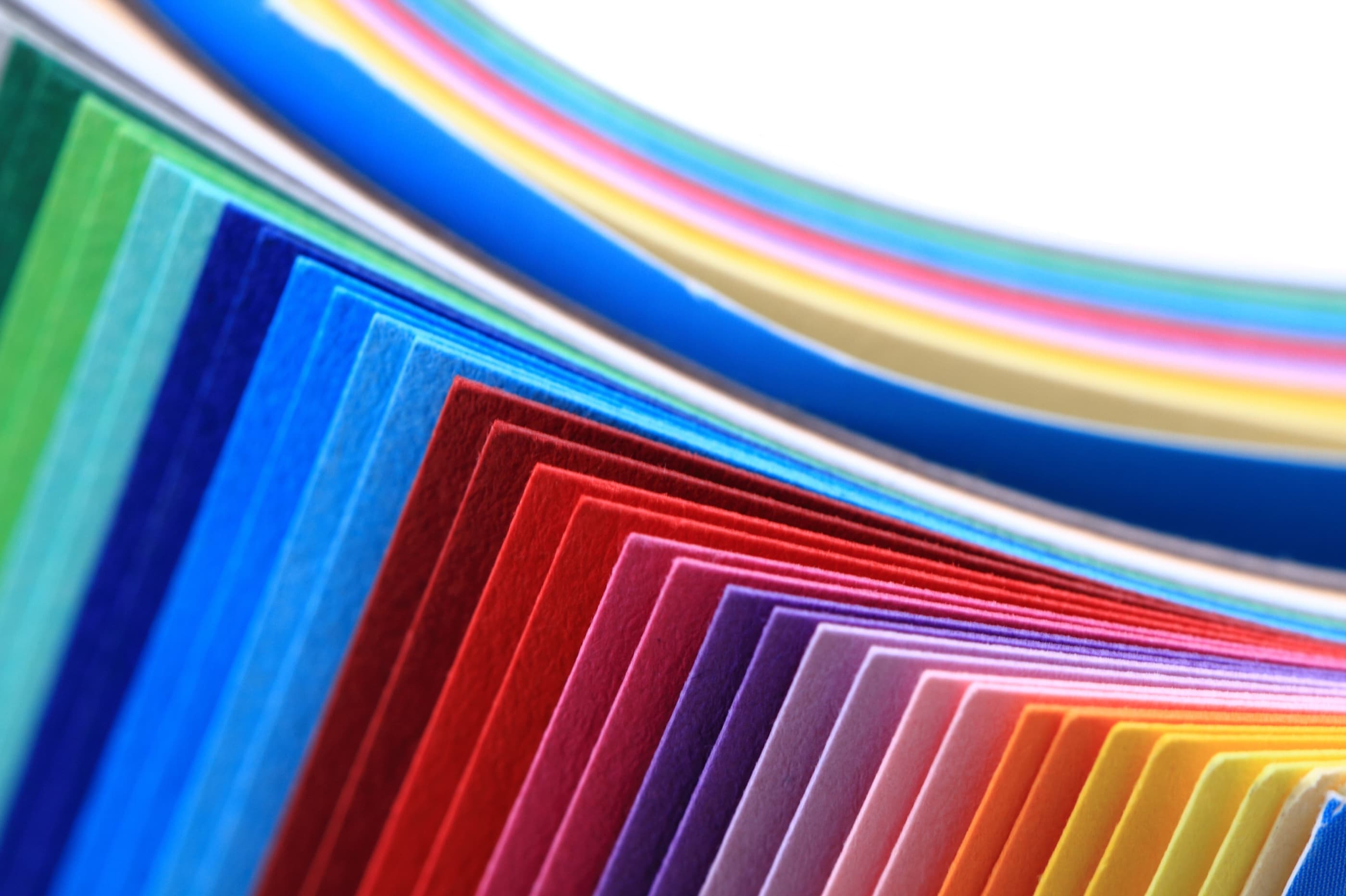 Fanned sheets of colored paper across the spectrum