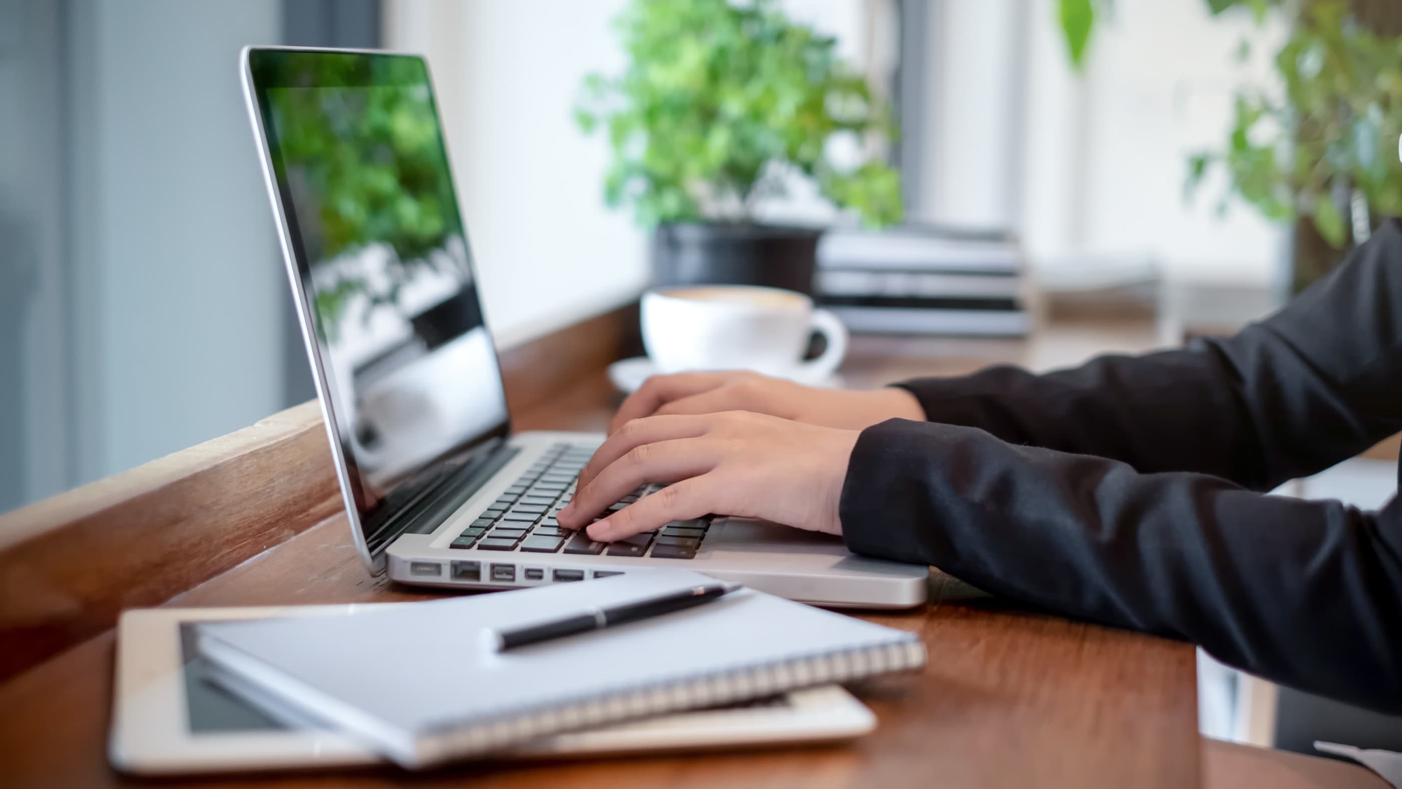 Hands placing an order on a laptop